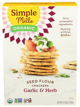 Simple Mills Cracker Seed Garlic Herb box on kitchen counter for quick snacking.