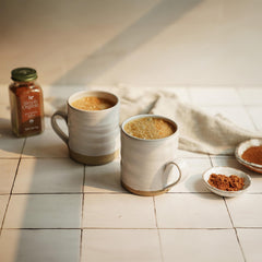 Measuring spoon with Simply Organic Pumpkin Spice over a mixing bowl.