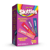 SINGLES TO GO Skittles Wild Berry sticks beside water for zero-sugar refreshment.