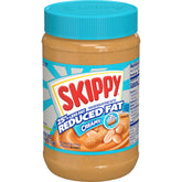SKIPPY Reduced Fat Creamy Peanut Butter jar on kitchen counter, convenient snack protein