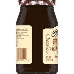 Spoon of Smucker's cider apple butter showing creamy texture.