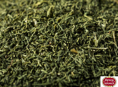 Open Spicy World dill weed bag with spoon, ready for quick seasoning.