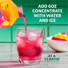 Glass with the bright drink and straw showcasing tropical hues