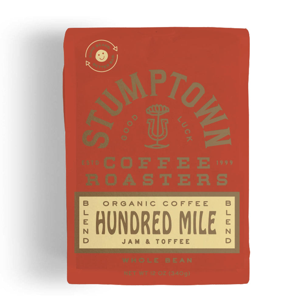 Stumptown Hundred Mile organic whole bean coffee bag front label showing jam and toffee notes, breakfast-friendly.