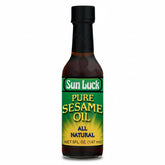 Sun Luck Pure Sesame Oil bottle pour enhances stir-fries with toasted aroma.