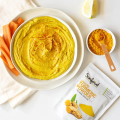 Sunfood Turmeric Powder bottle pouring, ideal for curries and rice dishes.