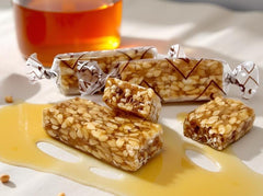 SweetGourmet sesame honey crunch texture close-up, golden seeds and sweet honey in each bite