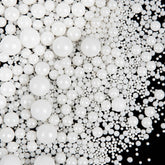 SweetGrove White Pearl Sprinkles on a cake for timeless wedding decoration.