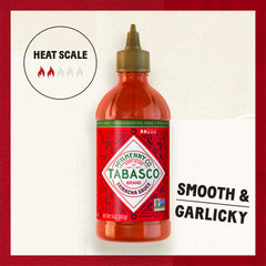 TABASCO Sriracha sauce being poured over noodles for bold flavor.