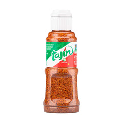Tajin Classic mini bottle pours on fruit for a bright lime kick