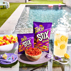 Takis Fuego Stix in hand portion showing portability and snack readiness