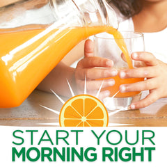 Pouring Tang Orange Mango into a glass reveals a vibrant, refreshing color.