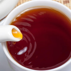 Steaming cup of Tapal Danedar black tea, inviting aroma and warmth.
