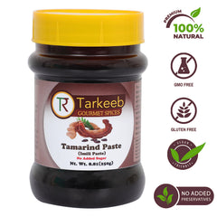 Tarkeeb Tamarind paste spoon dipping into a glossy glaze for marinades