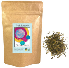 Tea and Trumpets decaf green tea leaves in a loose-leaf scoop, smooth, nutty flavor.