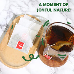 Cup of TEARELAE mugwort tea with rich amber color and inviting aroma.