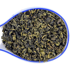 Brewed Ti Kuan Yin in a glass cup reveals amber color and delicate layers.