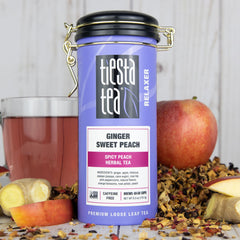 Tiesta Tea Ginger Sweet Peach tin with cup, perfect for refreshing iced tea.