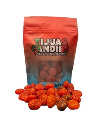 Tijuas Candies spicy chamoy gushers packaging closeup, bold colors and zesty aroma.