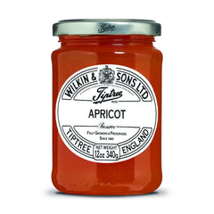 Tiptree Apricot Preserve jar on kitchen counter with chunky fruit, great on toast.