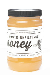TJO Bees raw honey jar front view with rich amber color ideal for on-toast drizzle.