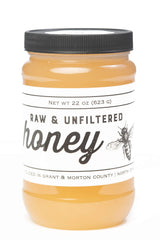 TJO Bees raw honey jar front view with rich amber color ideal for on-toast drizzle.