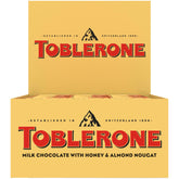 Toblerone Milk Chocolate Bar triangle peak close-up reveals honey almond nougat inside, ideal for sharing.