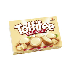 Toffifee White Chocolate close-up shows hazelnut center and creamy filling for a rich treat.