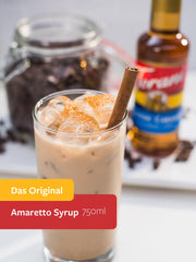 Torani Amaretto Syrup pouring into a cup for espresso drinks.