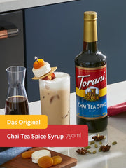 Torani Chai Tea Spice syrup being poured into a mug for cozy chai lattes.
