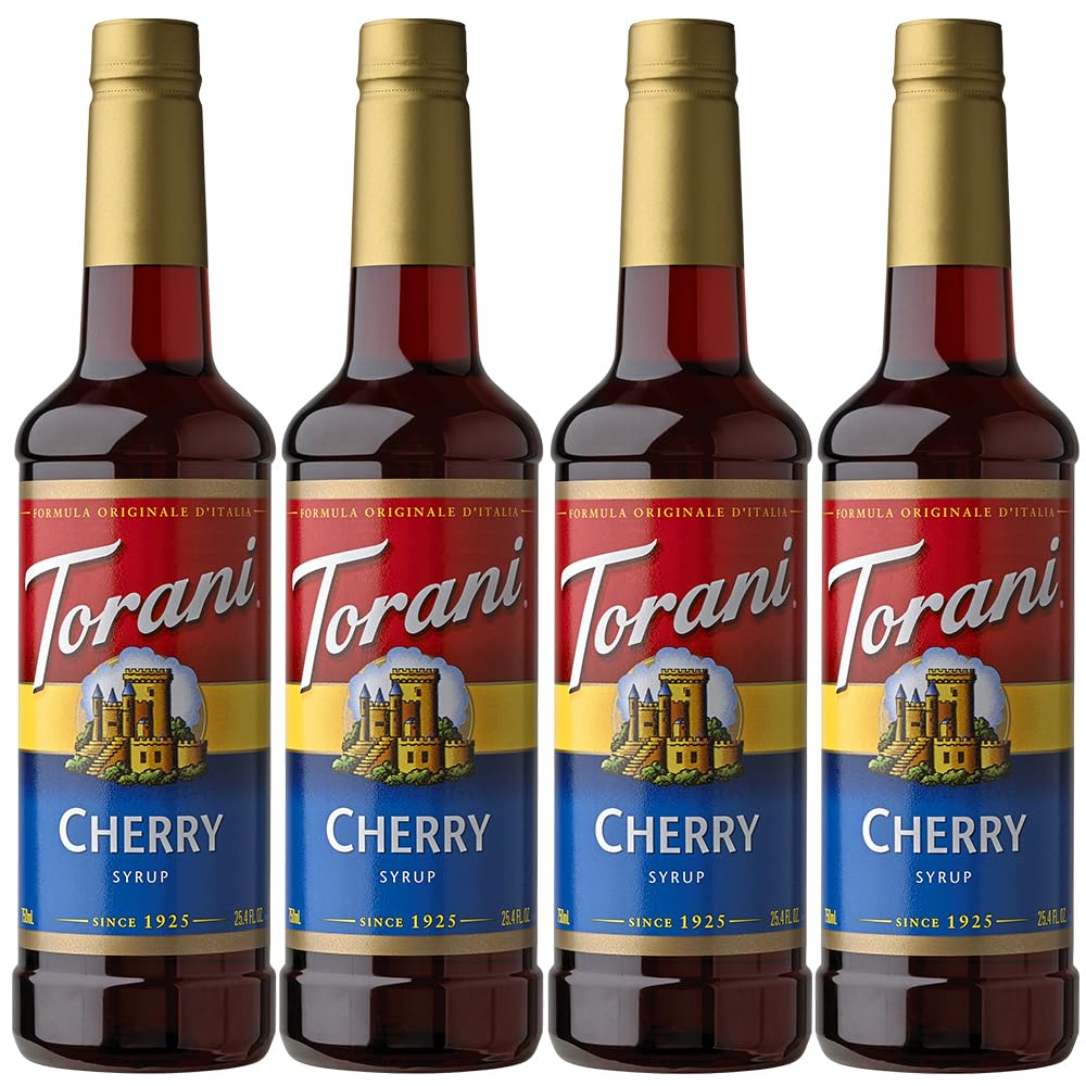 Torani Cherry Syrup bottle front view on a table, elevating everyday beverages with cherry flavor.