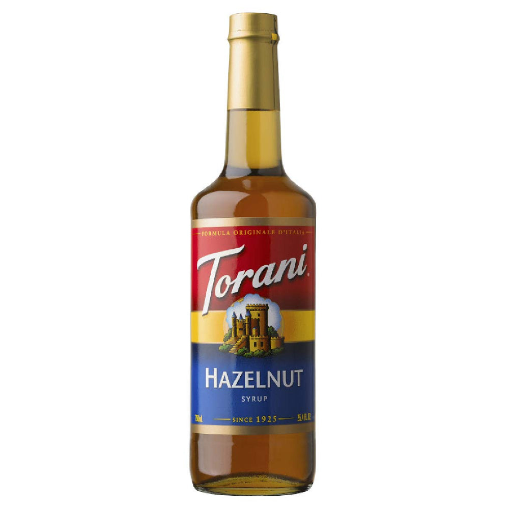 Torani Hazelnut Syrup bottle pour showcases rich nutty flavor for coffee and desserts.
