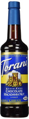 Torani Sugar Free Chocolate Macadamia Nut Syrup bottle on a kitchen shelf for sugar-free flavoring.