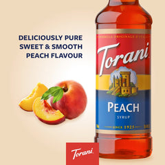 Torani Peach Syrup being poured over ice into a glass for refreshment.