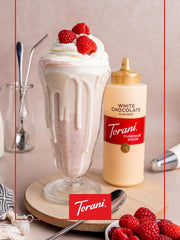 Torani White Chocolate Sauce on a cup ready for drizzling