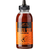 Traeger Que BBQ Sauce bottle ready to glaze succulent ribs and chicken.