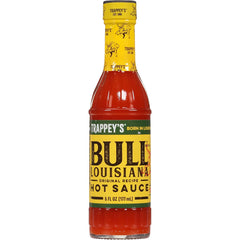 Trappey's Bull Brand hot sauce glass bottle in kitchen setup.