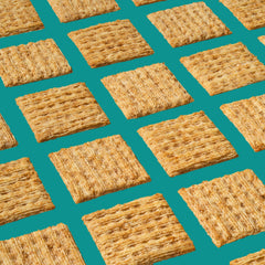 Triscuit Reduced Fat Whole Grain crackers close-up reveals crunchy woven texture for toppings.