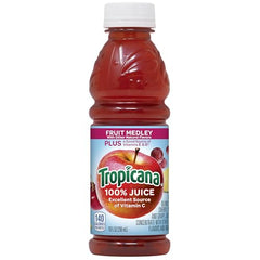 Pouring Tropicana Fruit Medley into a glass for refreshing nourishment.