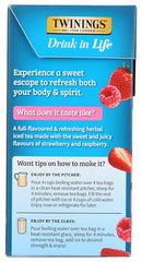 Twinings Strawberry and Raspberry brew poured into a glass with ice, showing vibrant color.