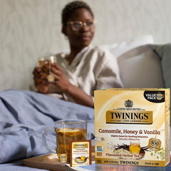 Close-up of a Twinings tea bag releasing aroma in hot water.