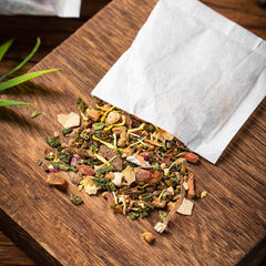ULTHMOK Tea bag closeup reveals visible herbs and natural quality.