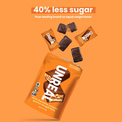 Close-up shows fluffy nougat with peanuts and caramel in rich chocolate.