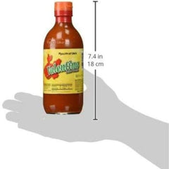 Valentina hot sauce being poured, instantly elevates grilled dishes.