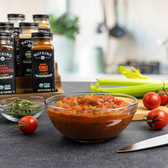 Watkins chili powder poured into a skillet for cooking