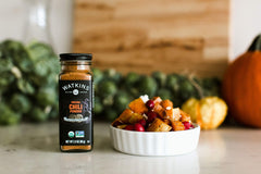 Watkins chili powder in recyclable glass highlights gluten-free and kosher attributes.