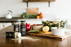 Pouring Watkins Onion Powder to season a skillet dish.