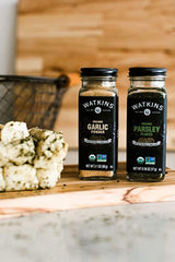 Watkins Parsley Flakes being poured, suggesting quick seasoning for recipes