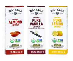 Pouring Watkins vanilla extract into batter to enhance sweetness and aroma.