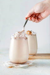 Pouring Watkins vanilla paste showing real vanilla bean specks